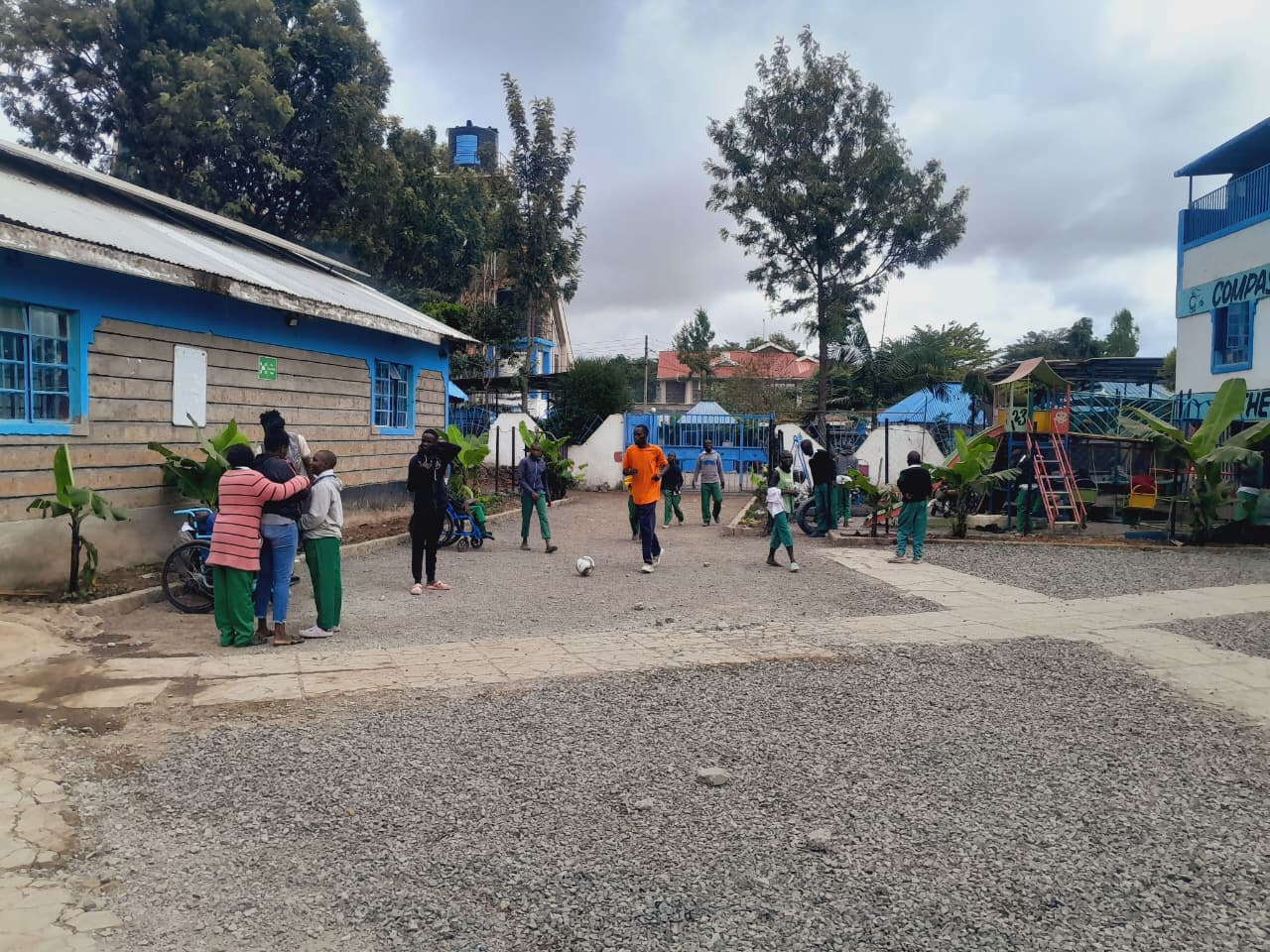 Children playing football in the CHDF compound