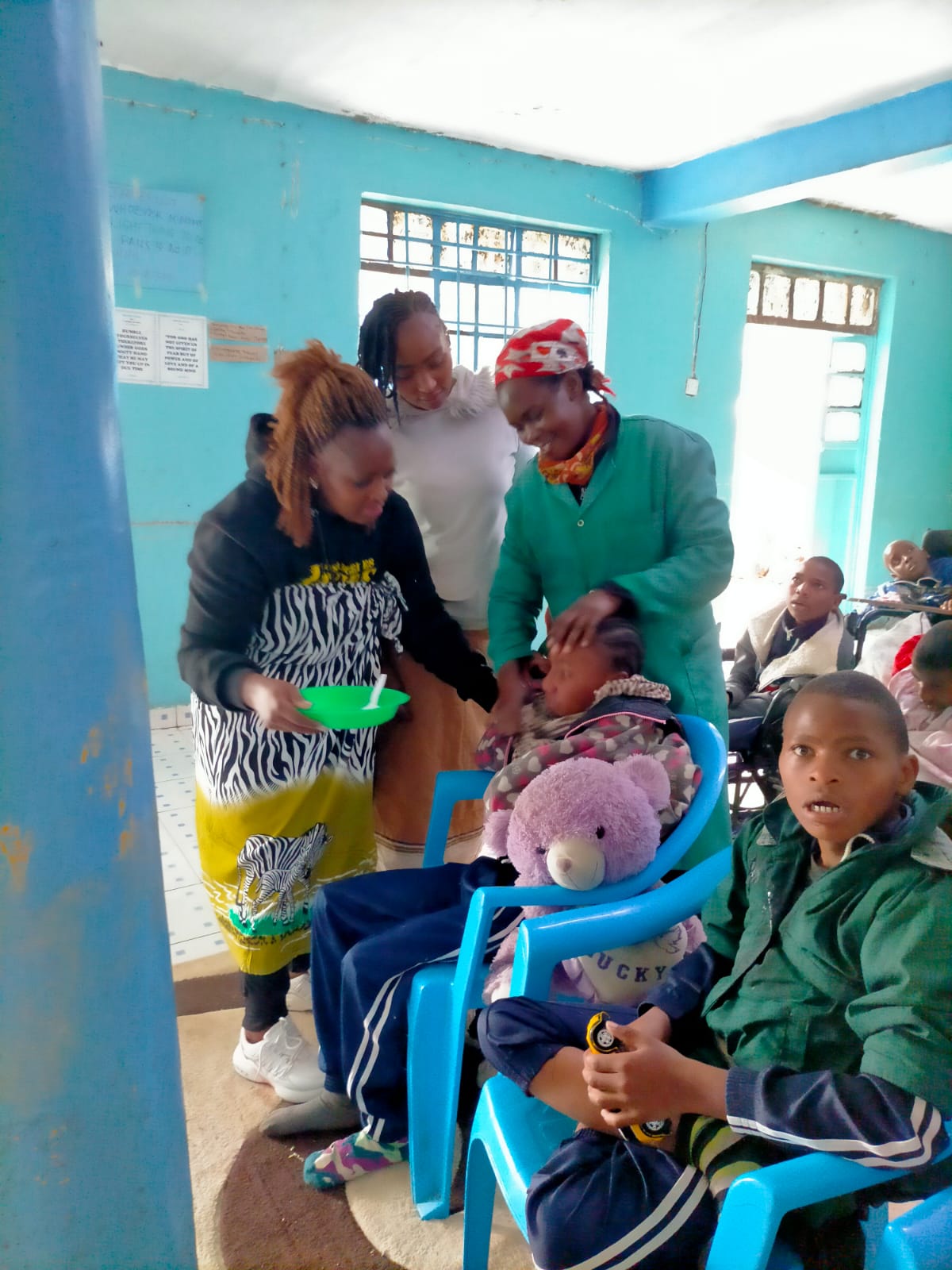 Caregivers feeding a child