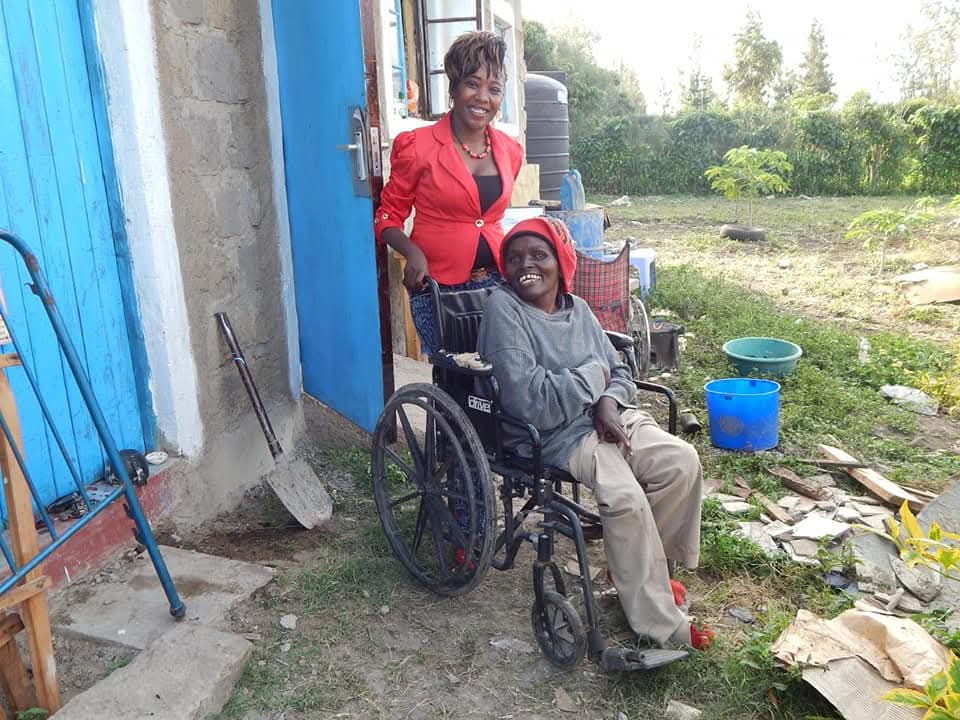 Founder with a beneficiary in a wheelchair